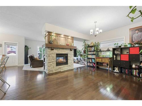 56 Jumping Pound Rise, Cochrane, AB - Indoor Photo Showing Living Room With Fireplace