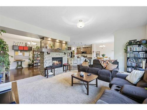 56 Jumping Pound Rise, Cochrane, AB - Indoor Photo Showing Living Room With Fireplace