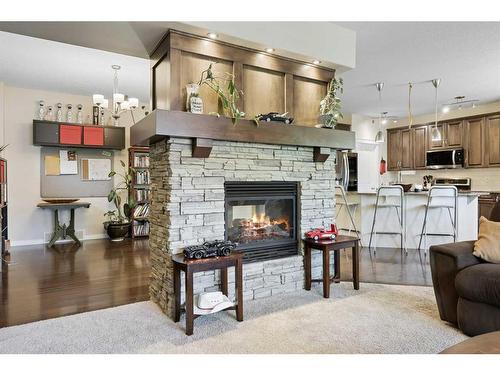 56 Jumping Pound Rise, Cochrane, AB - Indoor Photo Showing Living Room With Fireplace