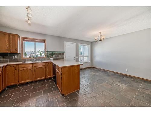 34 West Boothby Crescent, Cochrane, AB - Indoor Photo Showing Kitchen With Double Sink