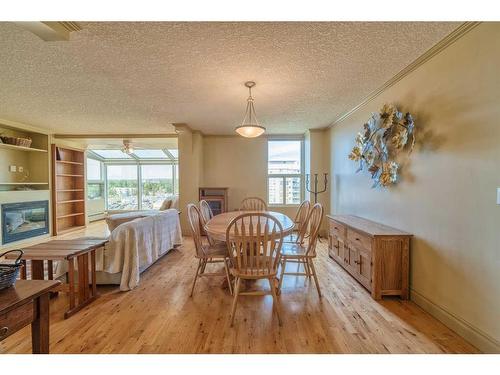 806-4554 Valiant Drive Nw, Calgary, AB - Indoor Photo Showing Dining Room With Fireplace