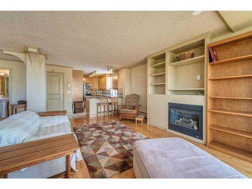 806-4554 Valiant Drive Nw, Calgary, AB - Indoor Photo Showing Living Room With Fireplace