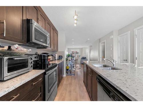 618 Cranford Mews Se, Calgary, AB - Indoor Photo Showing Kitchen With Double Sink With Upgraded Kitchen