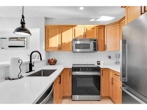 301-390 Marina Drive, Chestermere, AB - Indoor Photo Showing Kitchen With Stainless Steel Kitchen