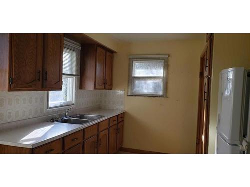 303 Armstrong Street, Carmangay, AB - Indoor Photo Showing Kitchen With Double Sink