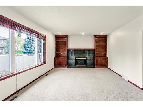 140 Evergreen Close Sw, Calgary, AB - Indoor Photo Showing Other Room With Fireplace