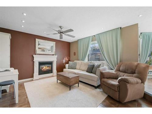 61 Riverside Circle Se, Calgary, AB - Indoor Photo Showing Living Room With Fireplace