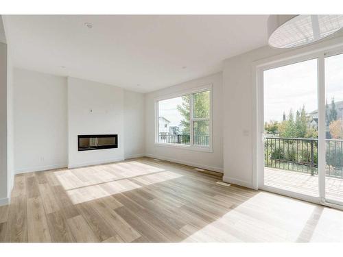 203 Silver Spruce Grove Sw, Calgary, AB - Indoor Photo Showing Living Room With Fireplace