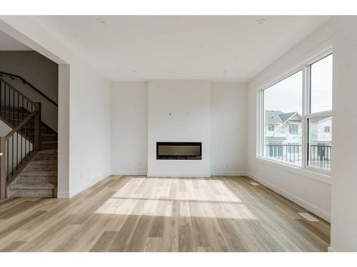 203 Silver Spruce Grove Sw, Calgary, AB - Indoor Photo Showing Living Room With Fireplace