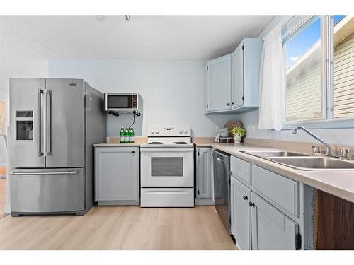 1639 Erin Drive Se, Airdrie, AB - Indoor Photo Showing Kitchen With Double Sink