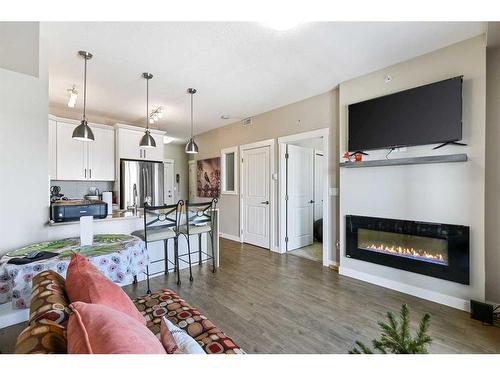 1416-130 Panatella Street Nw, Calgary, AB - Indoor Photo Showing Living Room With Fireplace