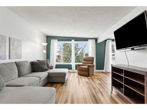 64 Pennsburg Way Se, Calgary, AB - Indoor Photo Showing Living Room