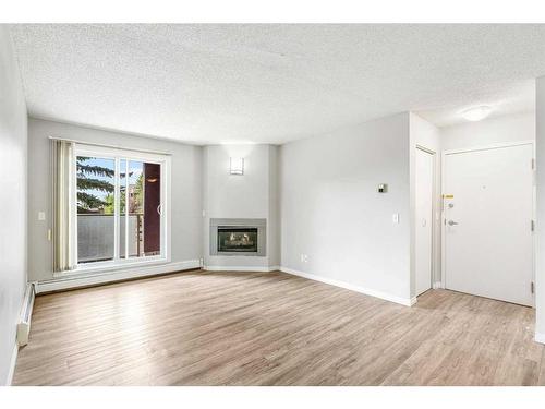 2821-3400 Edenwold Heights Nw, Calgary, AB - Indoor Photo Showing Living Room With Fireplace