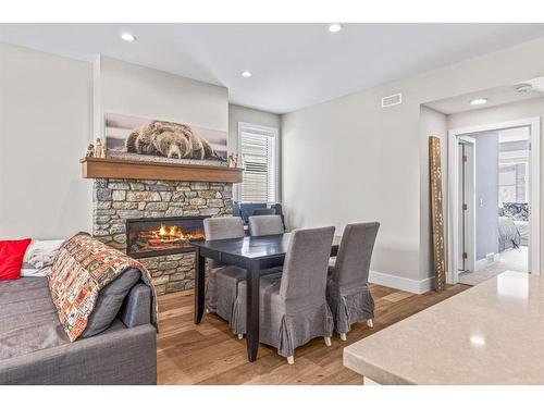 201G-1101 Three Sisters Parkway, Canmore, AB - Indoor Photo Showing Living Room With Fireplace