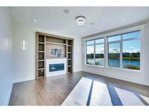 128 Kinniburgh Loop, Chestermere, AB - Indoor Photo Showing Living Room With Fireplace