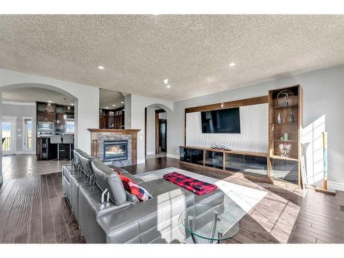 250040 Dynasty Drive West, Rural Foothills County, AB - Indoor Photo Showing Living Room With Fireplace