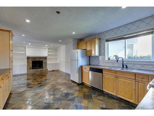 56 Millbank Close Sw, Calgary, AB - Indoor Photo Showing Kitchen With Double Sink