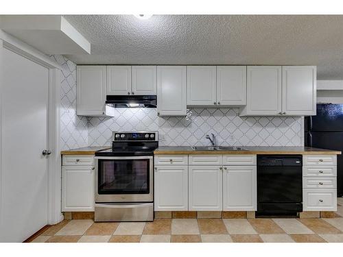 56 Millbank Close Sw, Calgary, AB - Indoor Photo Showing Kitchen With Double Sink