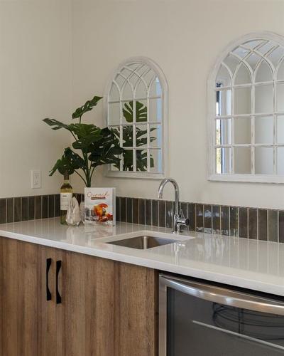 20 Monterra Landing, Rural Rocky View County, AB - Indoor Photo Showing Kitchen With Double Sink