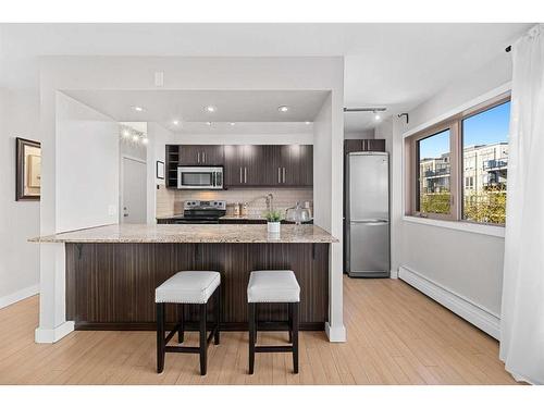 303-824 4 Avenue Nw, Calgary, AB - Indoor Photo Showing Kitchen With Upgraded Kitchen