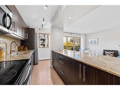 303-824 4 Avenue Nw, Calgary, AB - Indoor Photo Showing Kitchen With Upgraded Kitchen