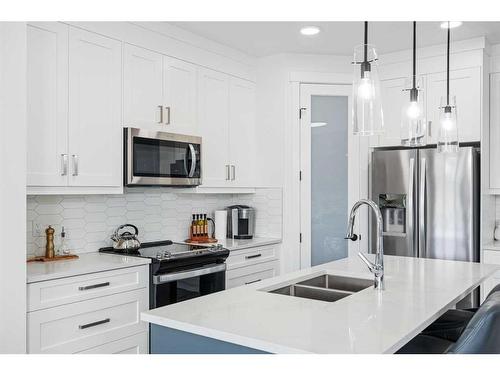 1033 Iron Landing Way, Crossfield, AB - Indoor Photo Showing Kitchen With Double Sink With Upgraded Kitchen