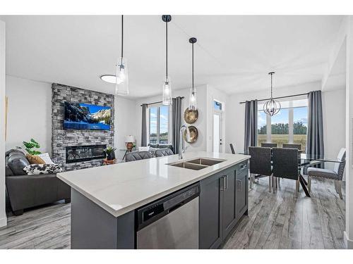 1033 Iron Landing Way, Crossfield, AB - Indoor Photo Showing Kitchen With Fireplace With Double Sink With Upgraded Kitchen