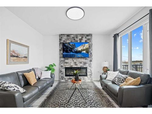 1033 Iron Landing Way, Crossfield, AB - Indoor Photo Showing Living Room With Fireplace