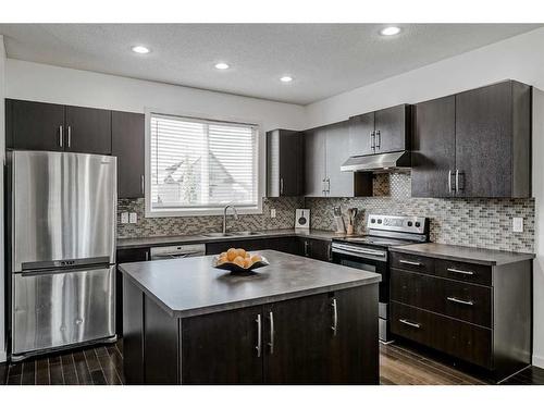 55 Sunset Link, Cochrane, AB - Indoor Photo Showing Kitchen With Stainless Steel Kitchen With Upgraded Kitchen