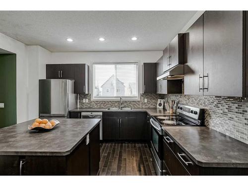 55 Sunset Link, Cochrane, AB - Indoor Photo Showing Kitchen With Stainless Steel Kitchen With Upgraded Kitchen