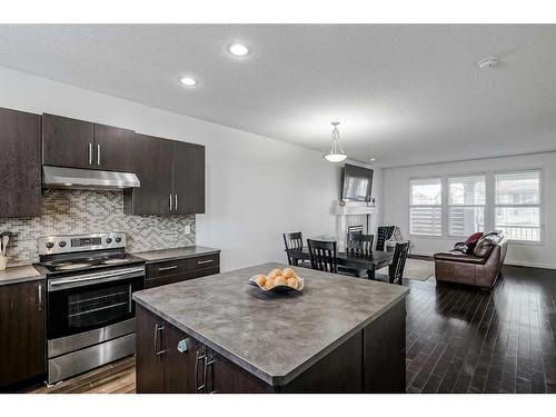 55 Sunset Link, Cochrane, AB - Indoor Photo Showing Kitchen With Upgraded Kitchen