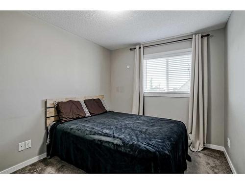 55 Sunset Link, Cochrane, AB - Indoor Photo Showing Bedroom