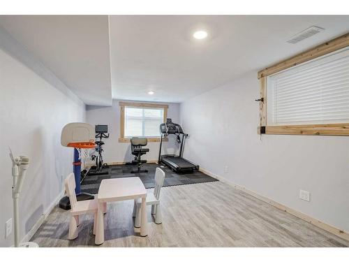 55 Sunset Link, Cochrane, AB - Indoor Photo Showing Gym Room