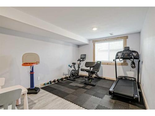 55 Sunset Link, Cochrane, AB - Indoor Photo Showing Gym Room