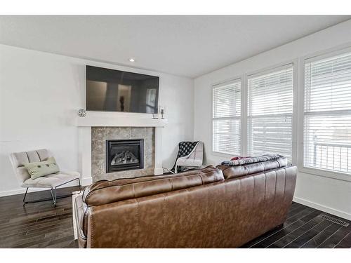 55 Sunset Link, Cochrane, AB - Indoor Photo Showing Living Room With Fireplace