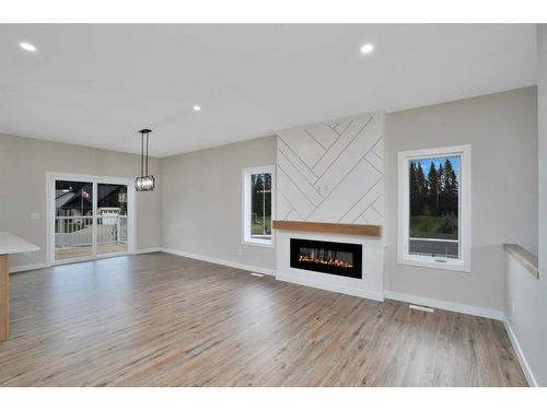 714 5 Street Sw, Sundre, AB - Indoor Photo Showing Living Room With Fireplace