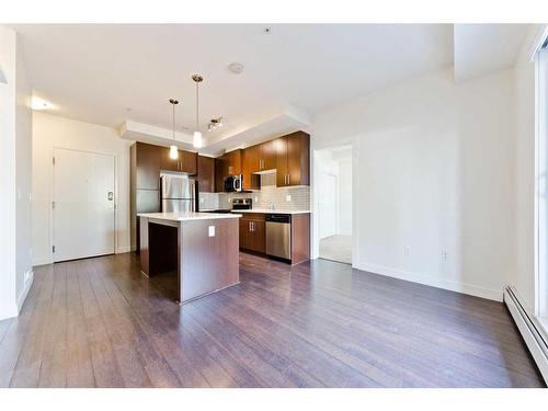 103-15233 1 Street Se, Calgary, AB - Indoor Photo Showing Kitchen With Stainless Steel Kitchen