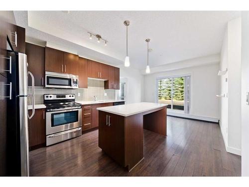 103-15233 1 Street Se, Calgary, AB - Indoor Photo Showing Kitchen With Stainless Steel Kitchen With Upgraded Kitchen