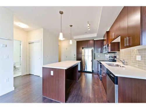 103-15233 1 Street Se, Calgary, AB - Indoor Photo Showing Kitchen With Stainless Steel Kitchen With Double Sink With Upgraded Kitchen