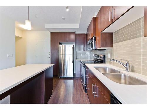 103-15233 1 Street Se, Calgary, AB - Indoor Photo Showing Kitchen With Stainless Steel Kitchen With Double Sink With Upgraded Kitchen