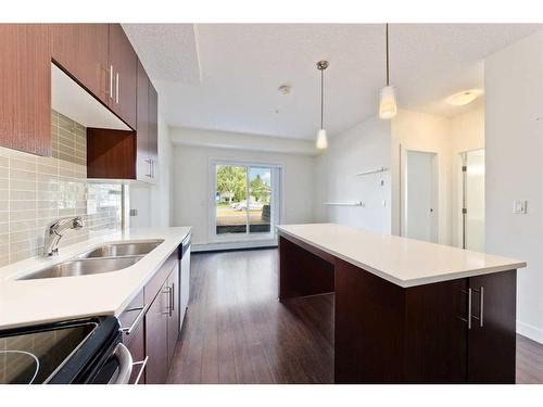 103-15233 1 Street Se, Calgary, AB - Indoor Photo Showing Kitchen With Double Sink With Upgraded Kitchen