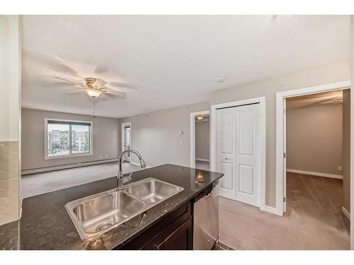 8410-403 Mackenzie Way Sw, Airdrie, AB - Indoor Photo Showing Kitchen With Double Sink