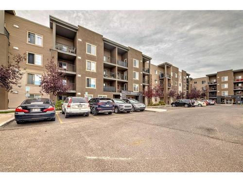 8410-403 Mackenzie Way Sw, Airdrie, AB - Outdoor With Balcony With Facade