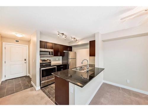 8410-403 Mackenzie Way Sw, Airdrie, AB - Indoor Photo Showing Kitchen With Stainless Steel Kitchen With Double Sink