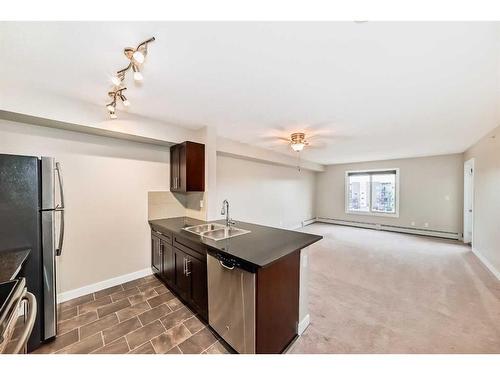 8410-403 Mackenzie Way Sw, Airdrie, AB - Indoor Photo Showing Kitchen With Double Sink