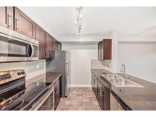 8410-403 Mackenzie Way Sw, Airdrie, AB - Indoor Photo Showing Kitchen With Stainless Steel Kitchen With Double Sink