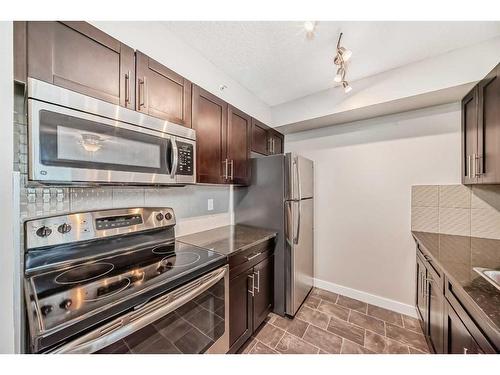 8410-403 Mackenzie Way Sw, Airdrie, AB - Indoor Photo Showing Kitchen With Stainless Steel Kitchen