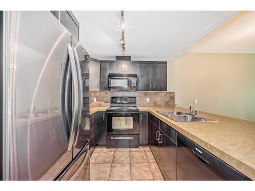 204-1410 1 Street Se, Calgary, AB - Indoor Photo Showing Kitchen With Double Sink