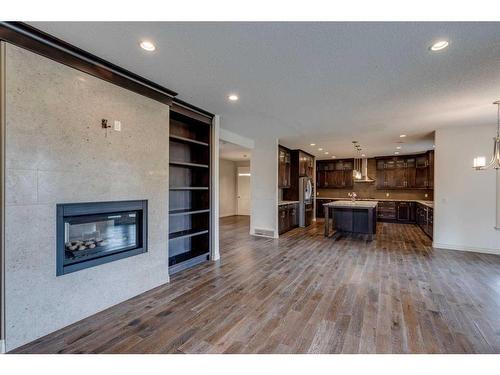 509 Hawk'S Nest Lane, Priddis Greens, AB - Indoor Photo Showing Living Room With Fireplace