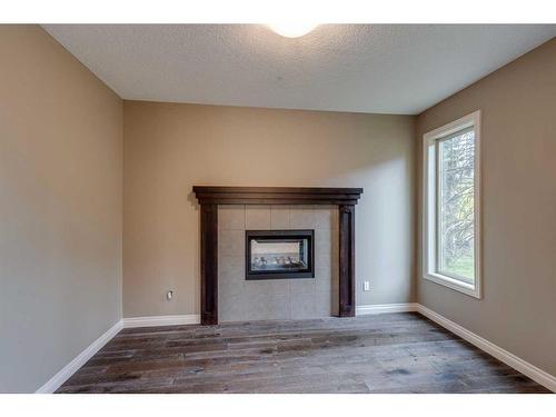 509 Hawk'S Nest Lane, Priddis Greens, AB - Indoor Photo Showing Living Room With Fireplace